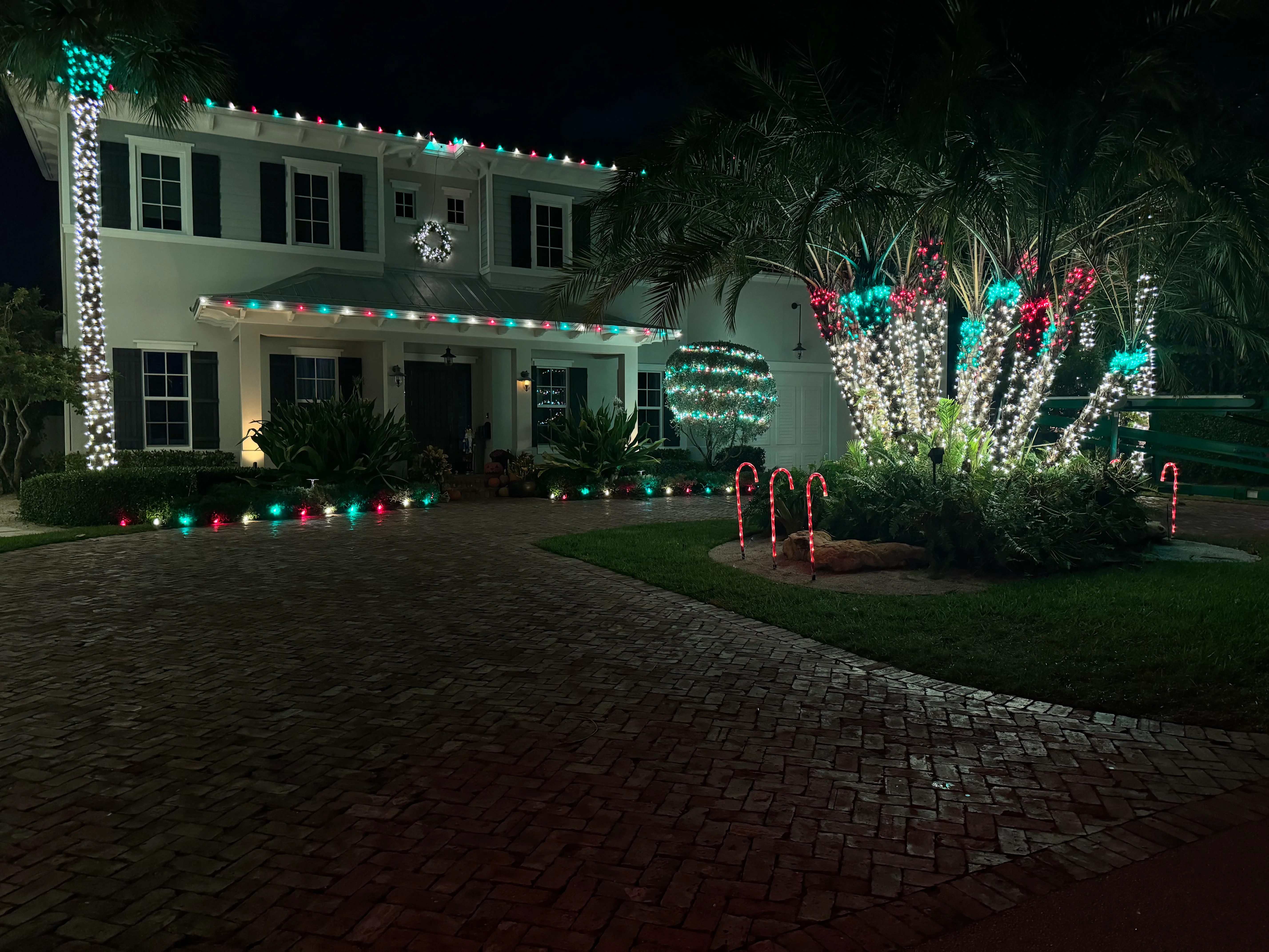 Beautiful festive house with colorful Christmas lights and candy cane decorations