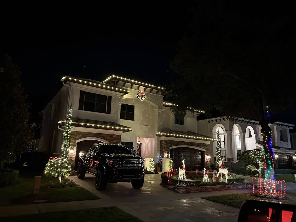 Christmas lighting installation with colorful LED displays and roofline lighting