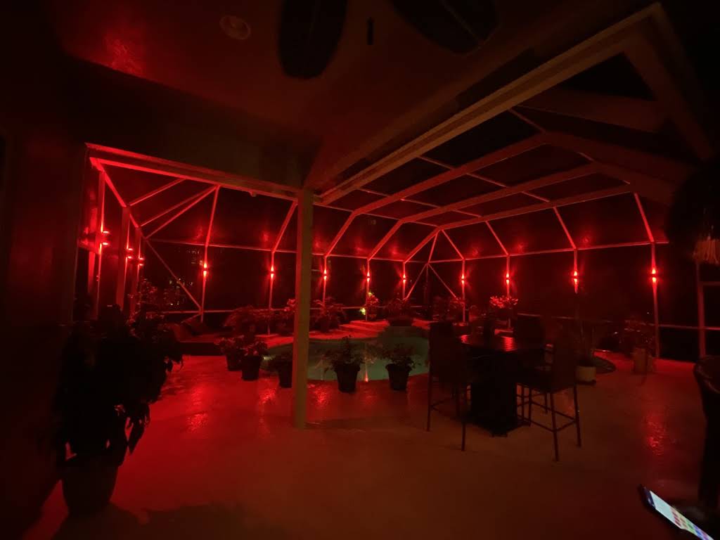 Pool enclosure with red LED accent lighting creating dramatic ambiance